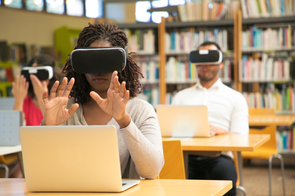 A student wearing VR glasses in a library, surrounded by peers engaging in digital learning through augmented reality